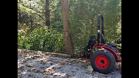 Pulling dead tree with Branson 2205h and a Badland...