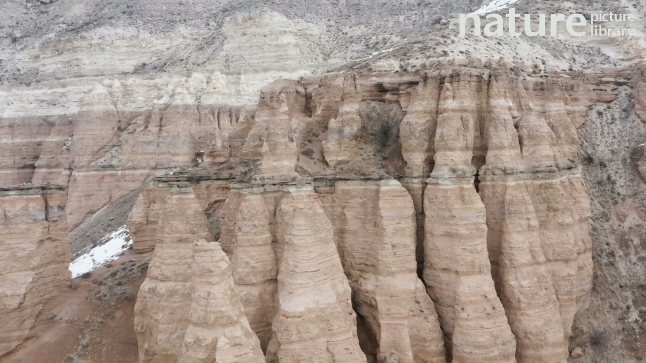 Aerial tracking shot of sandstone landscape eroded by weathering