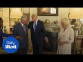 Charles jokes in front of Donald Trump as photographer's flash falls off camera