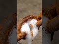 Hand removes rust from chain