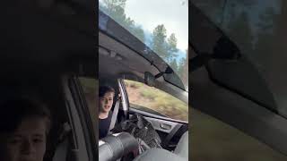 Umbrella Flies Away as Boy Tries to Hold Onto It While the Car Drives