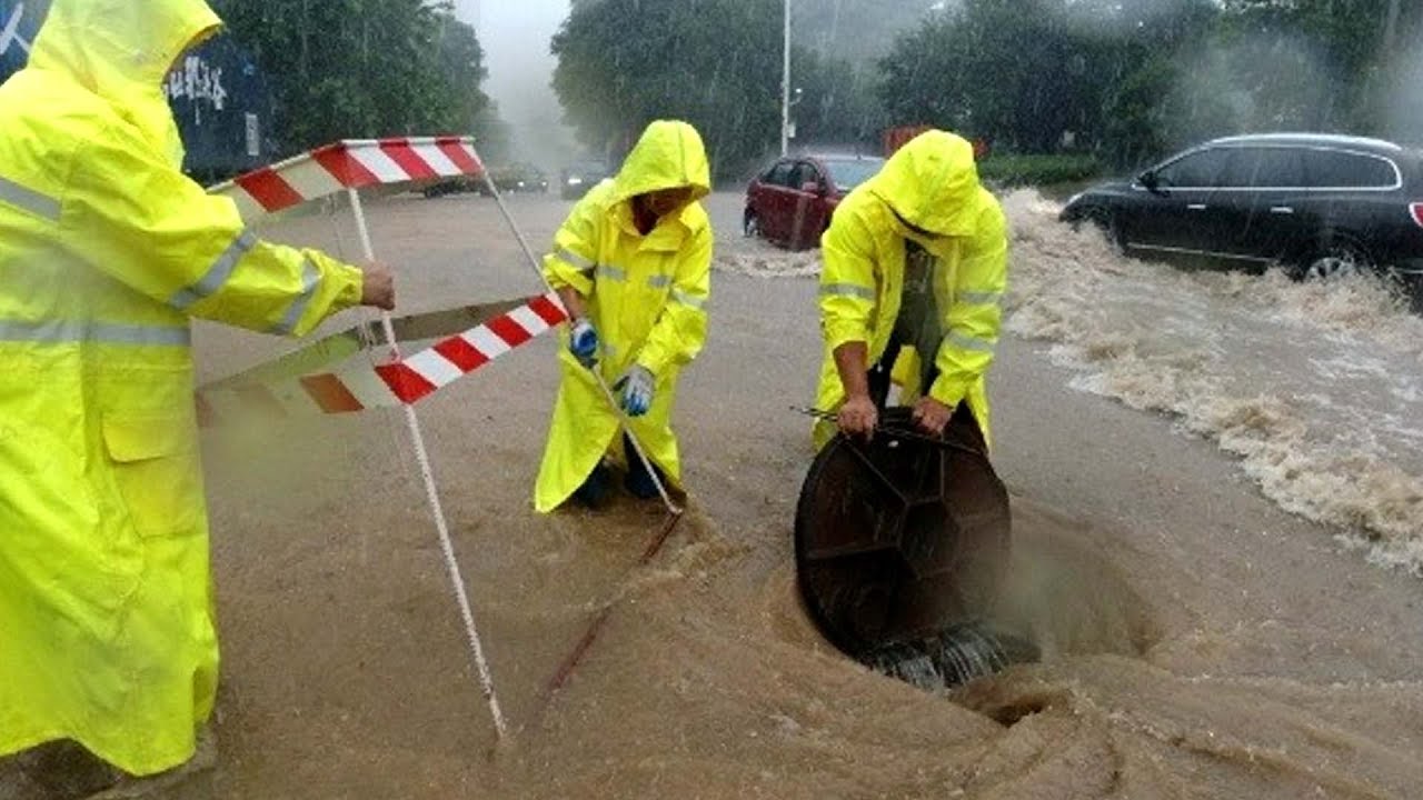 Draining the Deluge Unclogging a Flooded Street Drain for Fast Relief ...