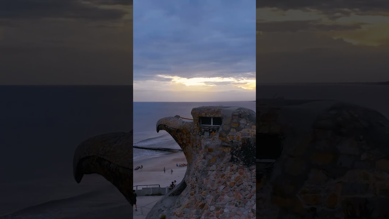 FPV drone flying around a big eagle stone head by the sea🎈 