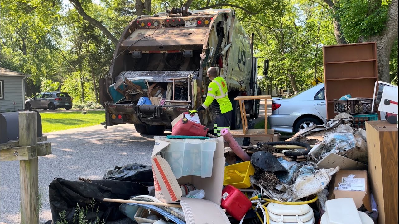 Ex Prairieland Disposal LRS International McNeilus Rear Loader Garbage Truck Packing a Massive Pile