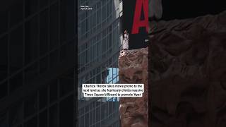Charlize Theron fearlessly climbs massive Times Square billboard to promote 'Apex'