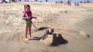 Quinn urging waves to take sandcastle