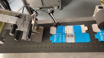 Automatic labelling machine for flat cardboard box