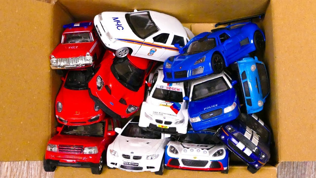 A box brimming with luxury diecast model cars. YouTube