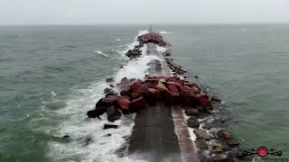 Flying The Break Wall In A Winter Storm As Waves Wash Over It 4K Drone Footage