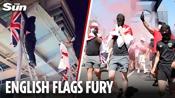 Masked men hang English FLAGS in Canary Wharf as 