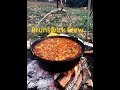 Brunswick Stew cooked over a camp fire in a Dutch Oven