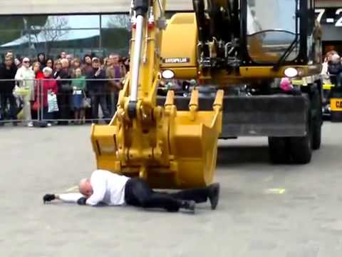 The man dancing with an excavator. Very tact and politely