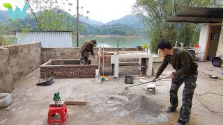 The father and his son upgraded their wooden house and built an outdoor kitchen next to the river
