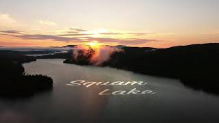 HD Drone aerial of Lake Squam, New Hampshire through the clouds at sunrise 2020