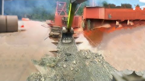 Barge unloading 4220 tons of phosphate rock - part 1 - Excavator working on barge