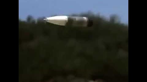 Bullet coming out of the barrel in slow motion,with a big boom,