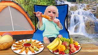 Jic Jic practices swimming in the stream at the campsite and eats fruit with his dad