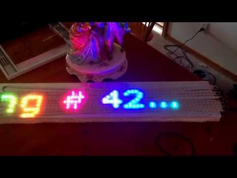 Netduino 60x10 NeoPixel panel marquee scrolling a transparent font over a rainbow background.