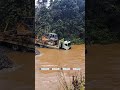 Trailer carrying bulldozer through the water.