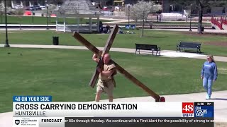 Stacy George celebrates Good Friday by carrying the cross through Big Spring Park