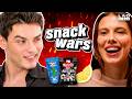 Millie Bobby Brown & Louis Partridge Go Head To Head In The Ultimate Snack Wars: Showdown