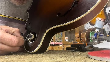Scraping the binding on an F5 style mandolin, preparing to apply finish