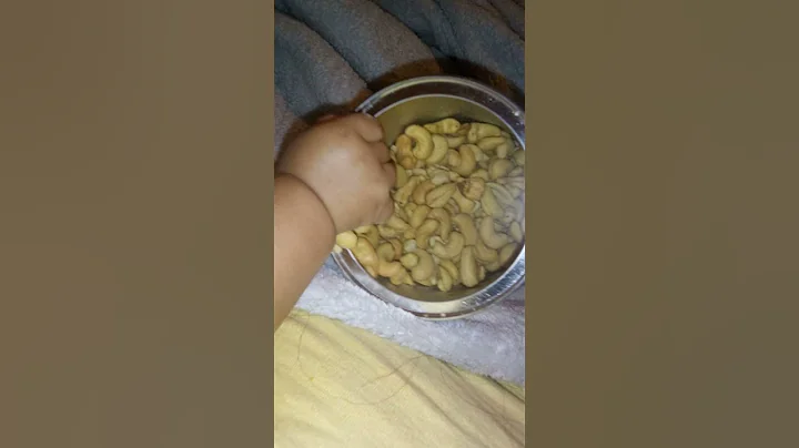 my granddaughter Aria is trying to steal my cashew...