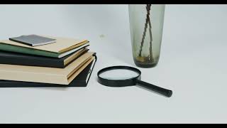 Books beside a Magnifying Glass