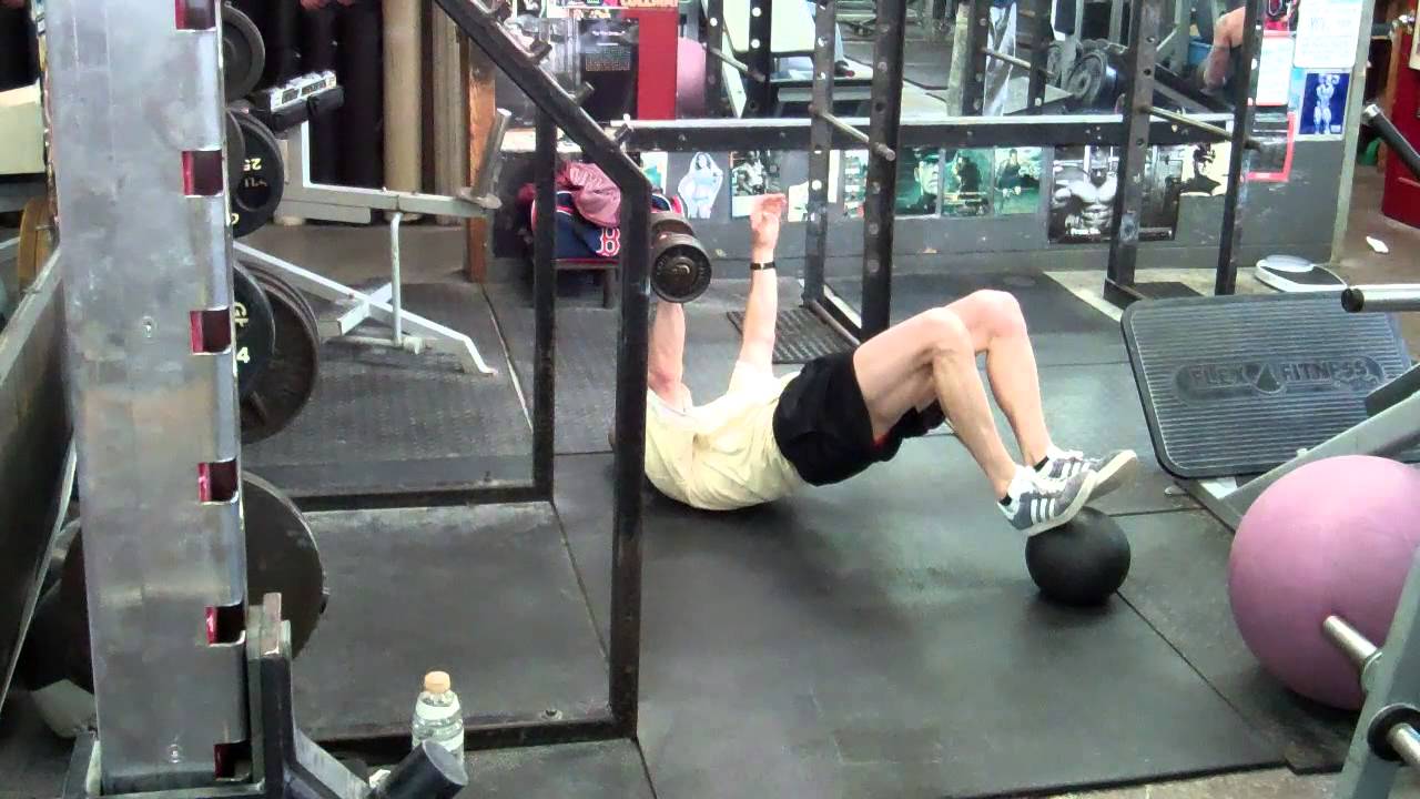 single arm med ball plank and DB row; med ball glute bridge with single