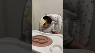 Guy throws white cheese at baby seated in high chair
