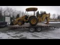 Using our John Deere 110 tractor loader backhoe to dig up an ice dam