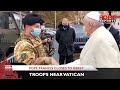 Pope Francis gets out of his car to greet troops near Vatican