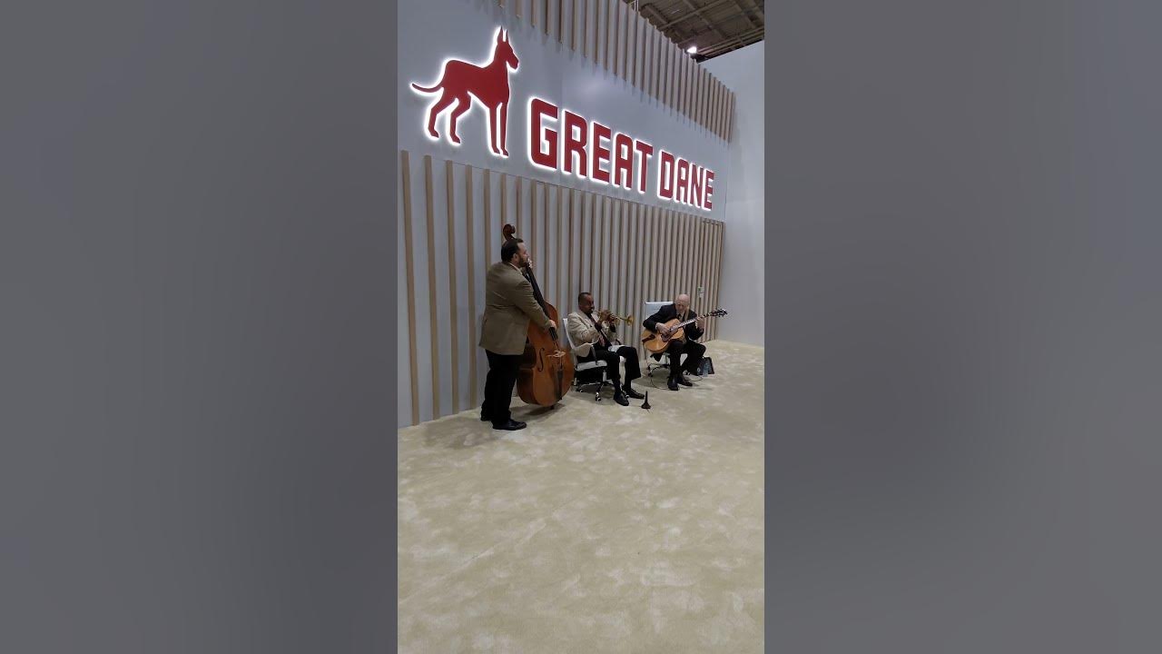 Three piece band playing Mack the Knife at the Great Dane trade show