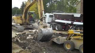 A Lamp: Cat 322 cl excavator working on the road