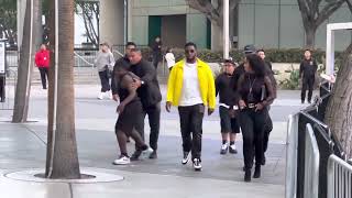 Sean Puffy Combs gives $100 bill to one of the candy kids at the Los Angeles Lakers game
