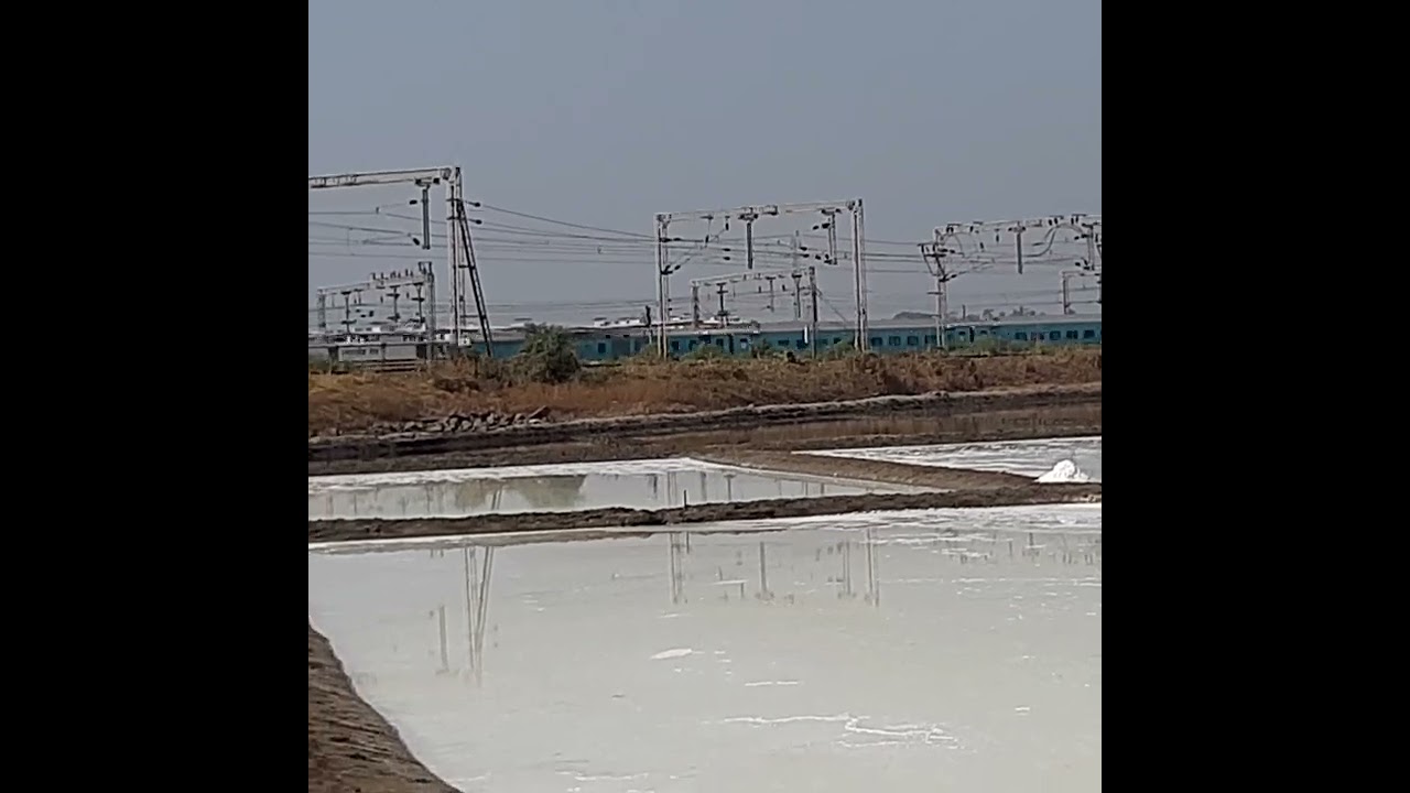 An express train going towards Mumbai - viewed from Vasai salt pans
