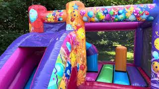 Multicoloured bouncy castle with inflatable slide