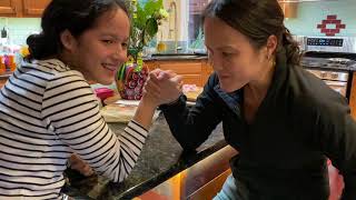 mother and daughter arm wrestling