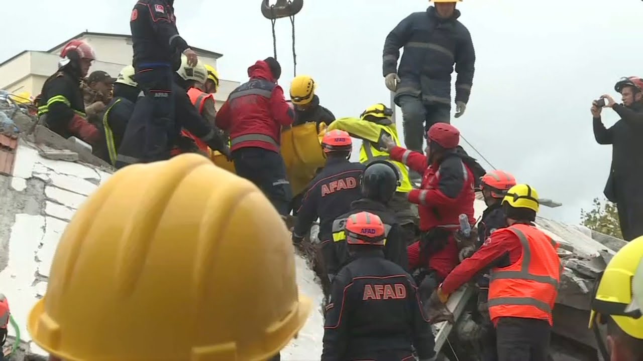 Albania: Rescue teams remove a body from the debris in Durres | AFP