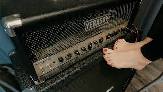 With Bare Feet Girl Tunes A Guitar Amplifier