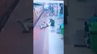 Woman Saved From Falling Under Moving Train