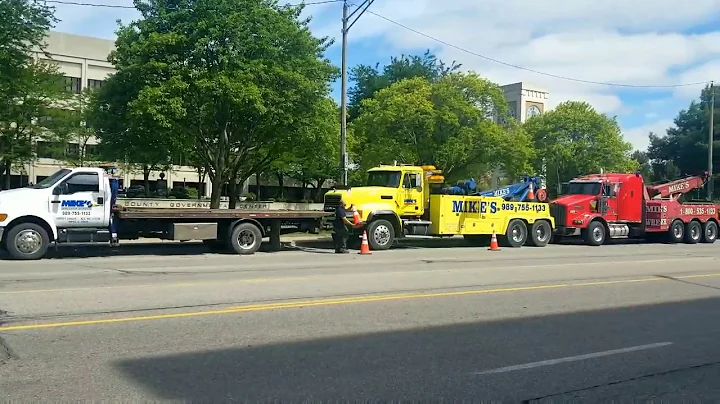 Tow Truck drivers gather outside courthouse as wom...