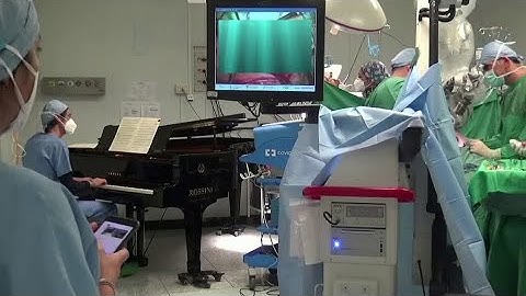 Boy has surgery as piano played next to operating table