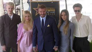 David Beckham poses with his family next to his star on the Hollywood Walk of Fame