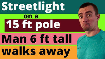 A STREET LIGHT IS MOUNTED AT THE TOP OF A 15-FT-TALL POLE. A MAN 6 FT TALL WALKS AWAY FROM THE POLE