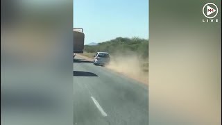 Car fails to overtake truck, flies through bushes