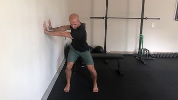 Athletic stance t-spine rotation wall press