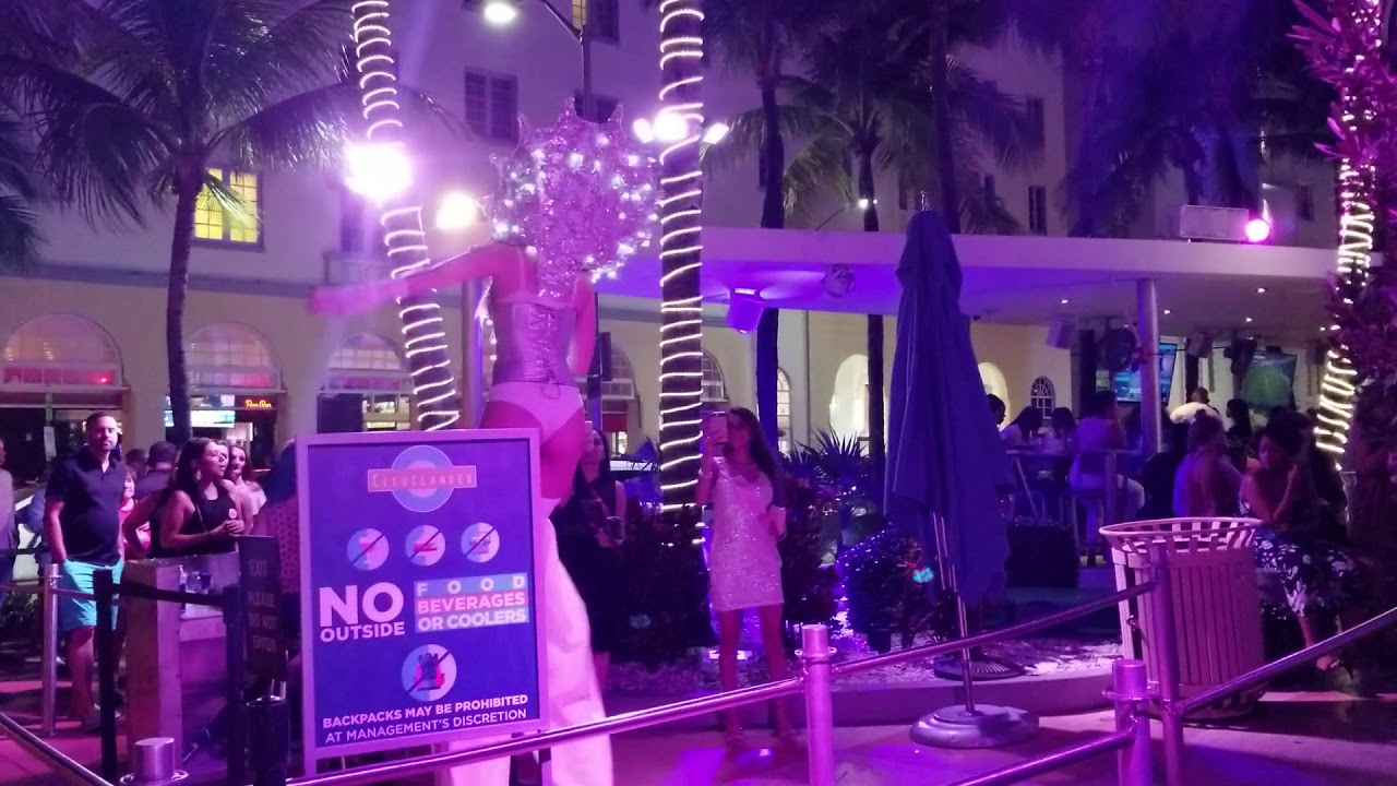 9 foot tall exotic dancer in front of club.. Miami South Beach.. - YouTube