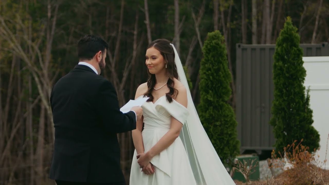 Groom reading his vows to his bride among the trees at The Overlook at KC Bison Ranch in Dahlonega, GA
