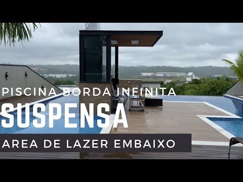 piscina-borda-infinita-com-bar-molhado-e-suspensa-terreno-declive
